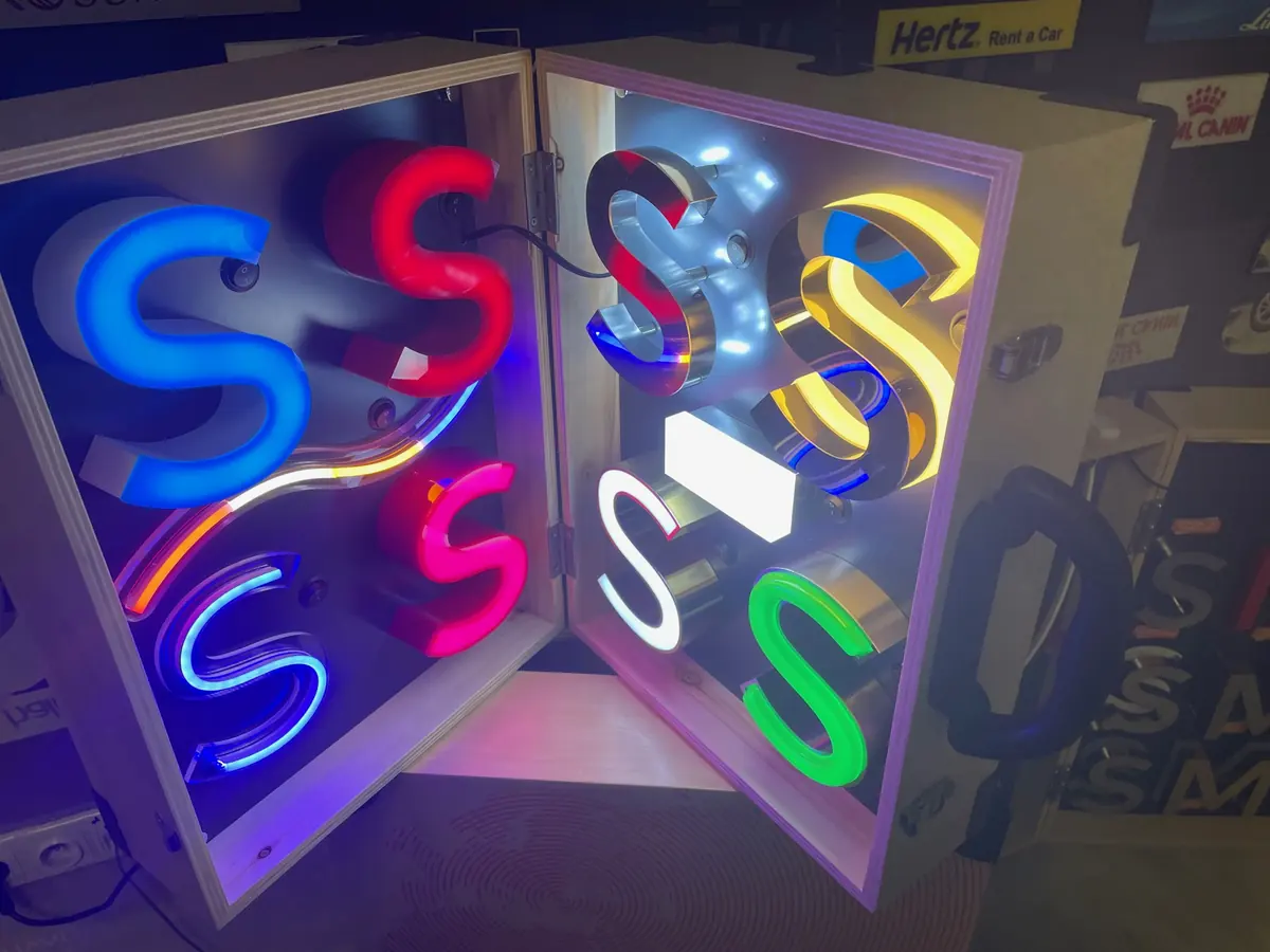 Illuminated acrylic sample letters in several colours inside a display case